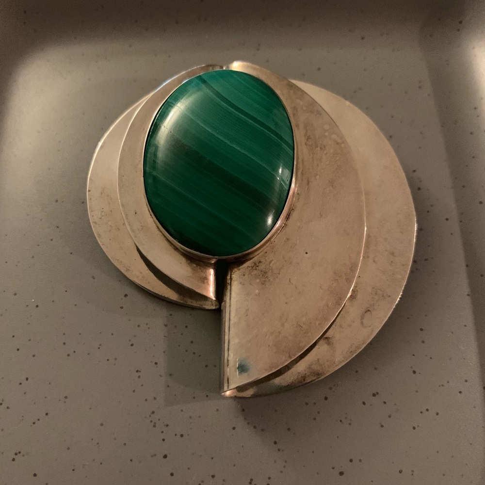 Sterling silver pin with green stone